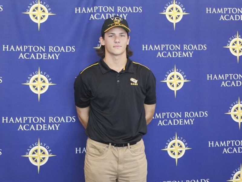 Student Colby Motley posing in front of HRA backdrop