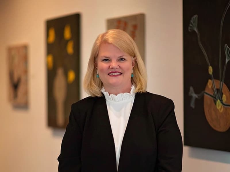 alumni in the news portrait of blonde woman in black suit