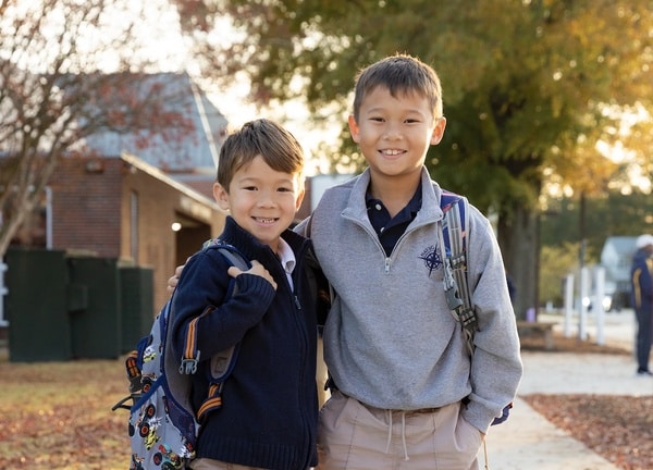 brothers hugging outside hampton roads academy lower school