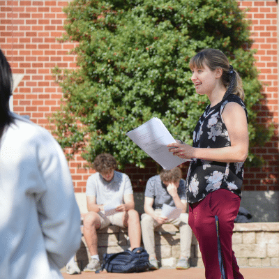 HRA teacher talking to students outside, representing 2024-25 school year, representing the Year of Kindness