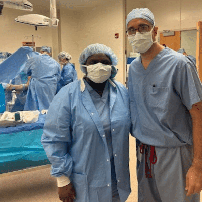 Male and female New Horizons Upper School students in a healthcare setting wearing medical attire, representing Hampton Roads Academy