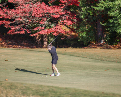 HRA Golf Classic participant with fall foliage