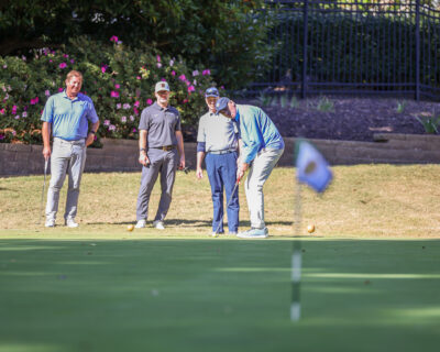 Head of School Jay Lasley putts at the 2024 HRA Golf Classic