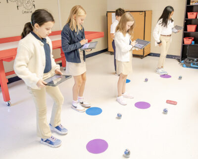 HRA fourth graders program Sphero robots to navigate the space of the Robotics Room