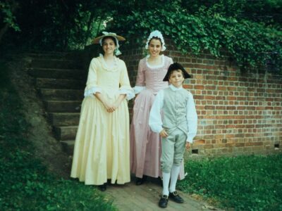 HRA alumni Lisa Schmidt Ha-Ngoc ’00, Kita Schmidt McCord ’00, and David Schmidt ’05 in colonial garb