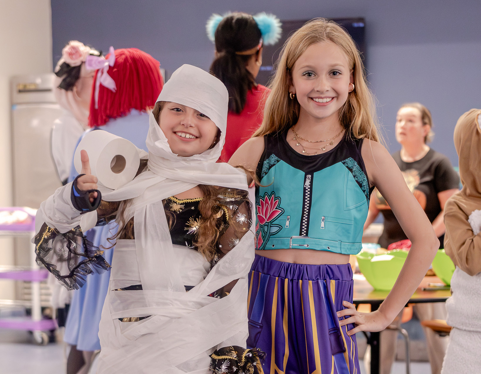 Middle Schoolers compete in a mummy-wrapping contest at Halloween Happenings 2025