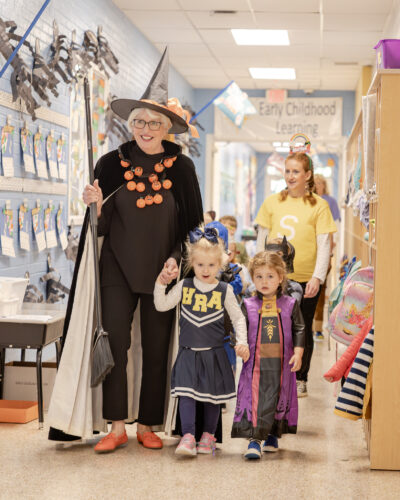 Director of Lower School Susanne Swain '78 leading the 2025 Lower School Halloween parade