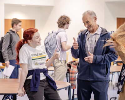HRA Alumna CJ Erwin '25 and Director of Alumni Relations Tommy Yevak '83 at the 2026 Alumni College Fair