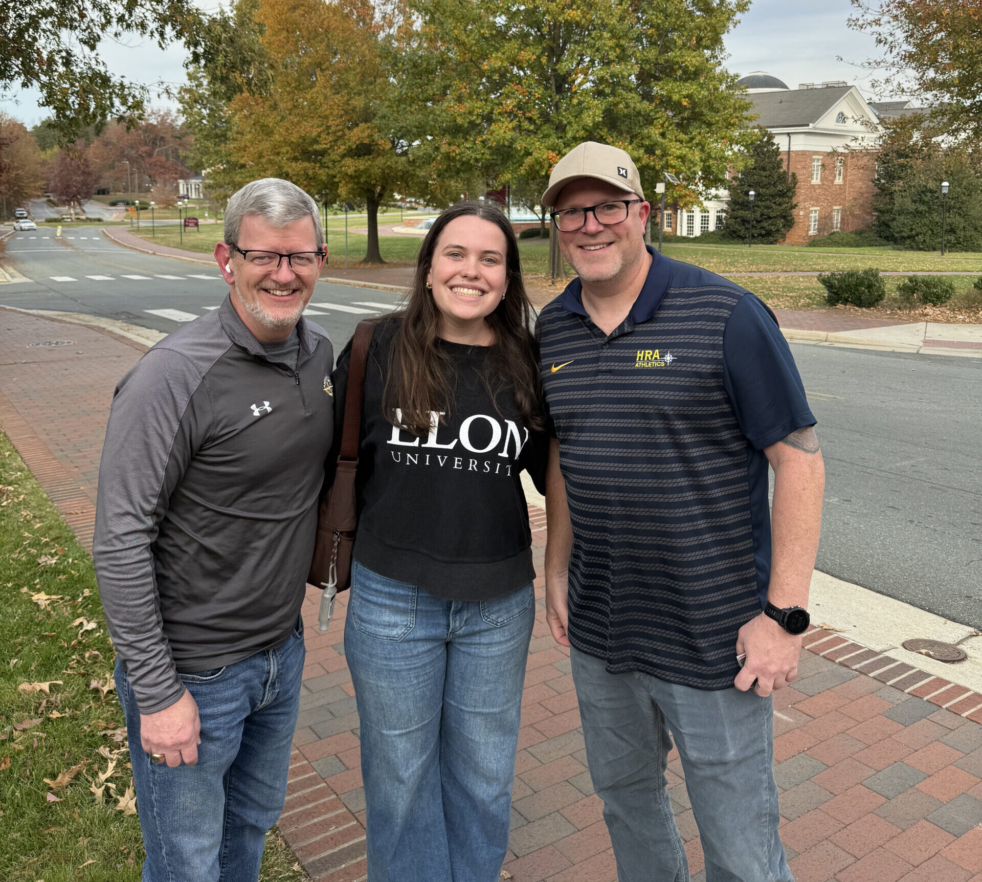 HRA's Associate Director of College Counseling Christopher Hailey and Upper School English teacher Jeremy Clover reconnect with alumna Cassie Dornan ’23—no stranger to the agony of waiting for admissions decisions—at Elon University