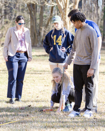 Members of HRA's Sustainability Club mark the boundaries of the site they will be rewilding