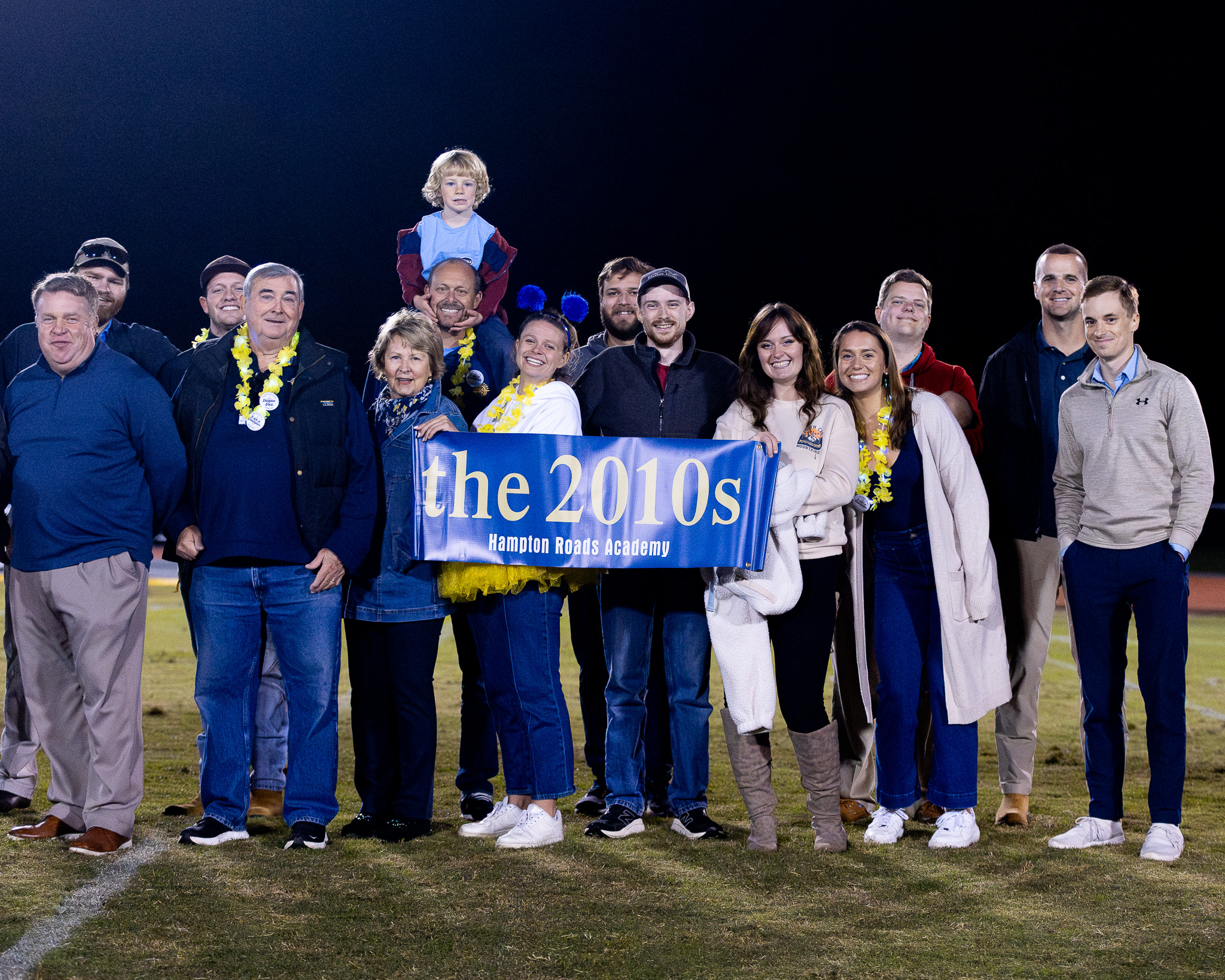 Alumni from the 2010s line up during halftime at HRA's 2025 Homecoming football game