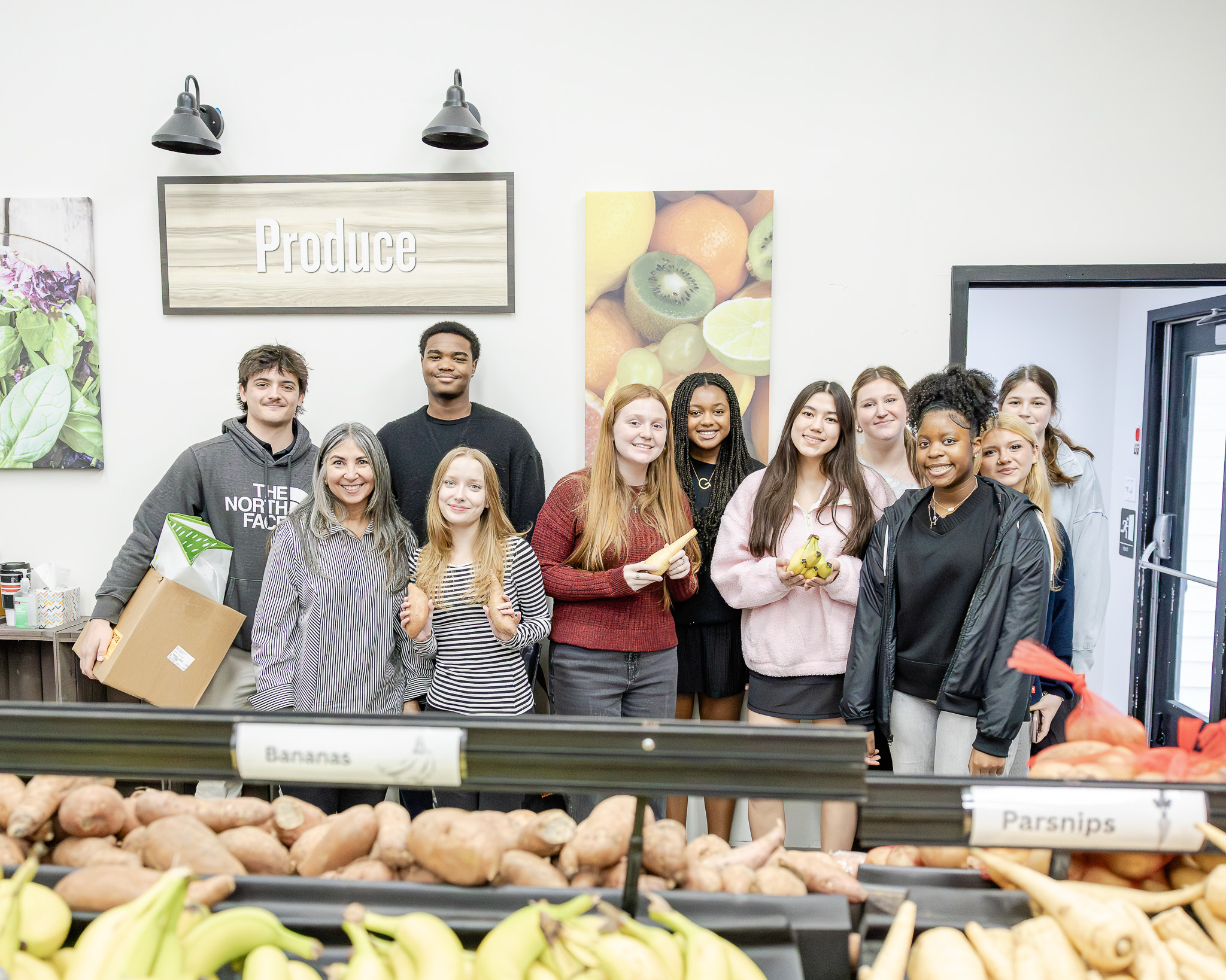 HRA Upper School science teacher Dr. Maribel Gendreau with her anatomy and physiology class at THRIVE Peninsula food pantry