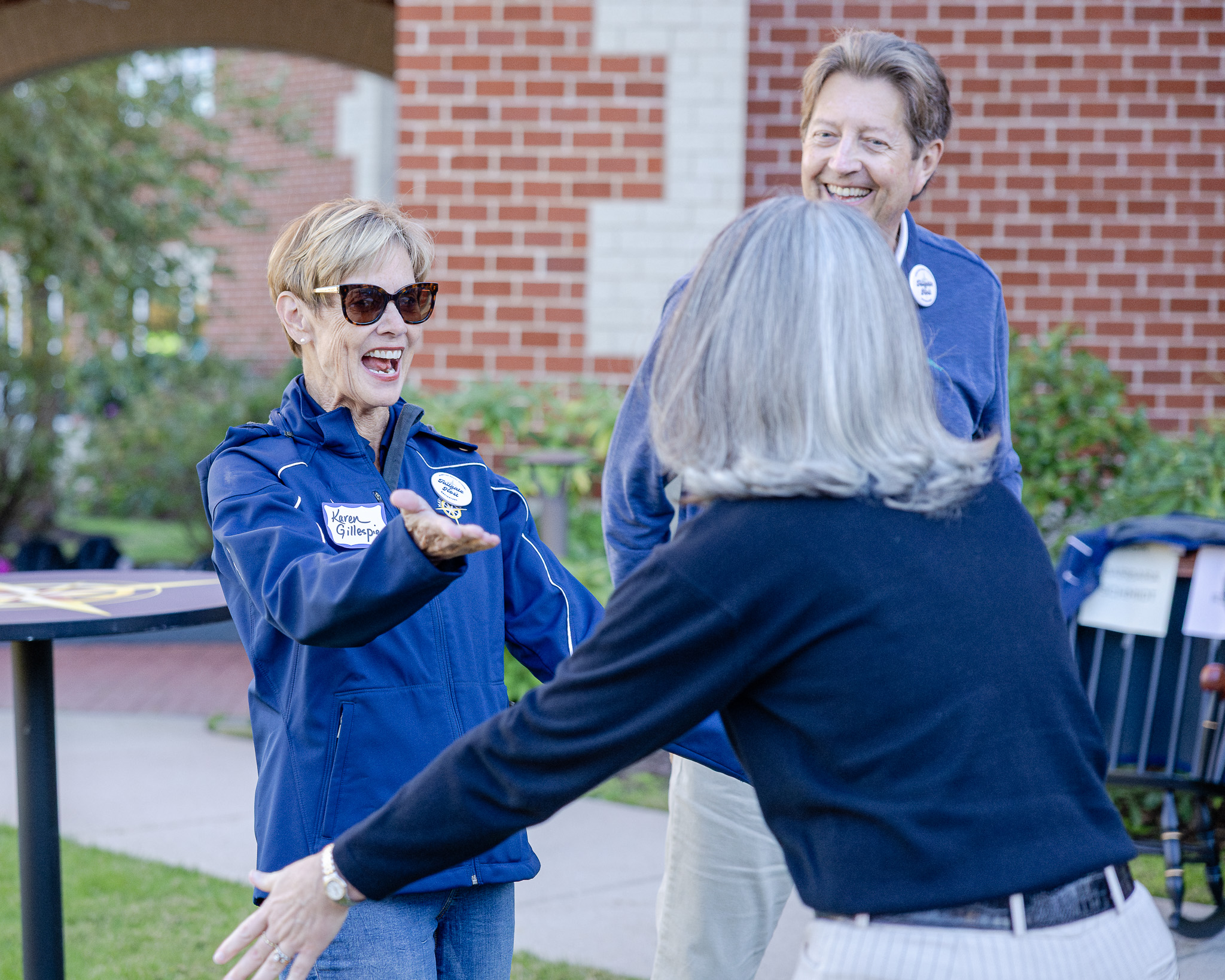 Interim Director of Middle School Karen Gillespie and former Director of Athletics Max Gillespie reconnect with alumni at the 2025 HRA All-Alumni Tailgate