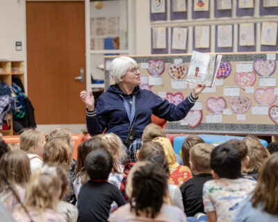 HRA Director of Lower School Susanne Swain '78 reading to children on Winter Story Day