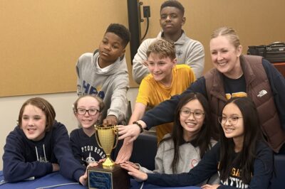 HRA's Battle of the Books team posing with their trophy after winning the 2026 Newport News City Finals