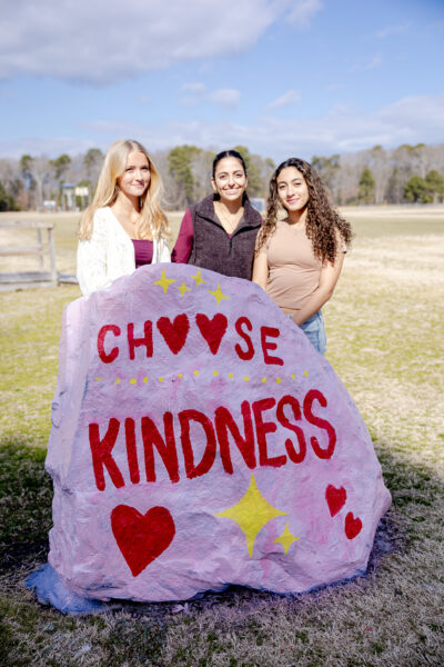 HRA Upper Schoolers Lucy Lanier '28, Indira Hartke '27, and Shay Berdous '28 with the school spirit rock during Operation Smile's Spread the Love Week 2026