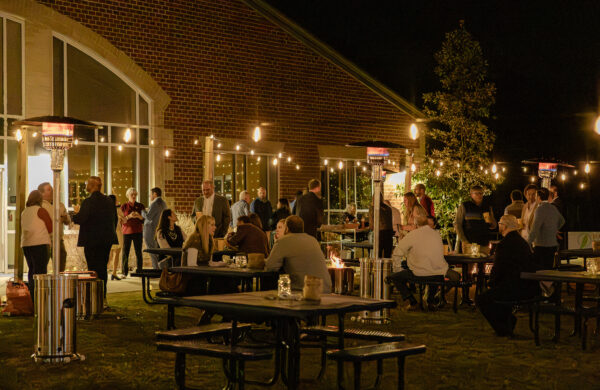 Guests gathering outdoors at HRA's Tidewater Table & Auction fundraiser