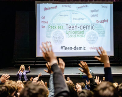 Students raising hands as highway safety advocate Tammy Guido McGee presents at HRA