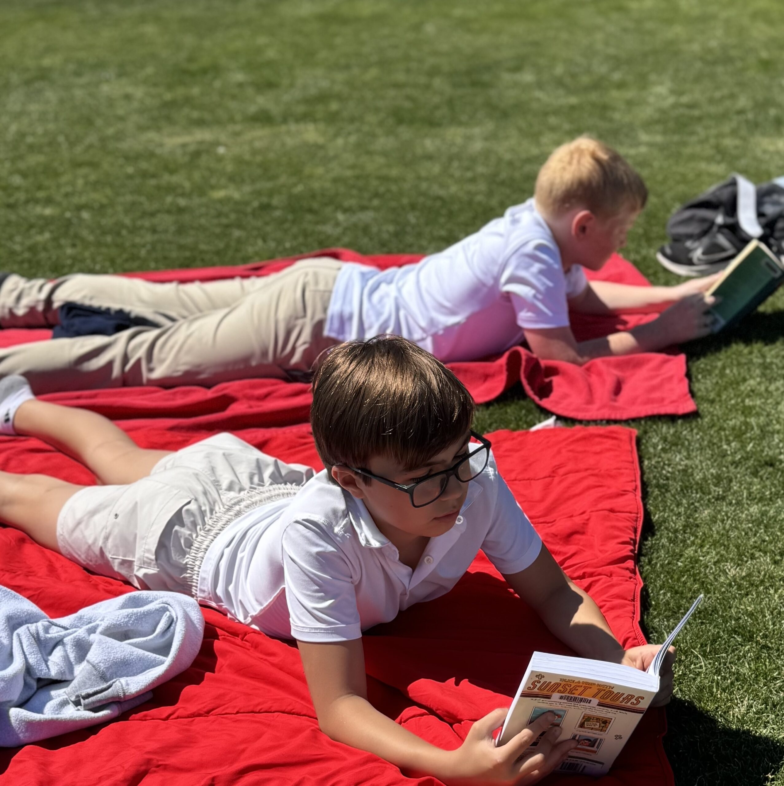 HRA Middle School students reading outdoors