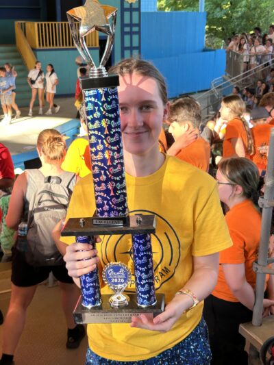 HRA student holding the trophy for First Place Class A Concert Band at Music in the Parks 2026