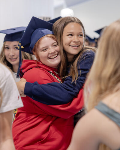 Senior and Middle Schooler hug during the 2026 HRA Senior Parade