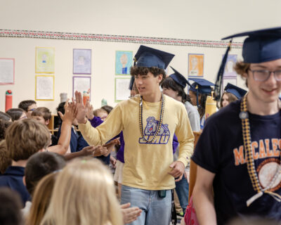 Lower Schoolers high-fiving seniors during the 2026 HRA Senior Parade