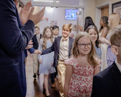 HRA seniors greeting fifth graders in the hallway following Convocation 2026