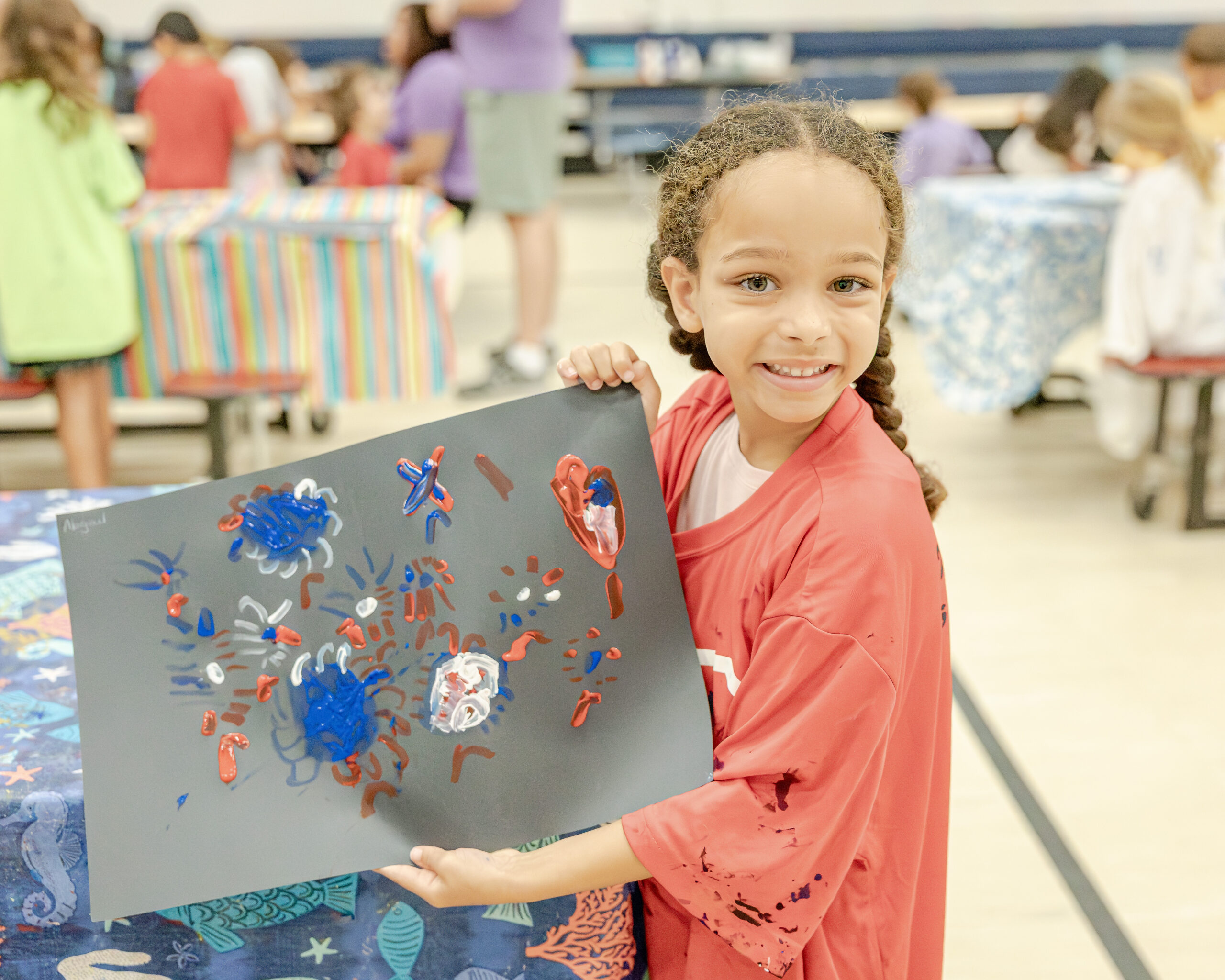 An HRA camper displaying a Fourth of July firework painting during summer 2026