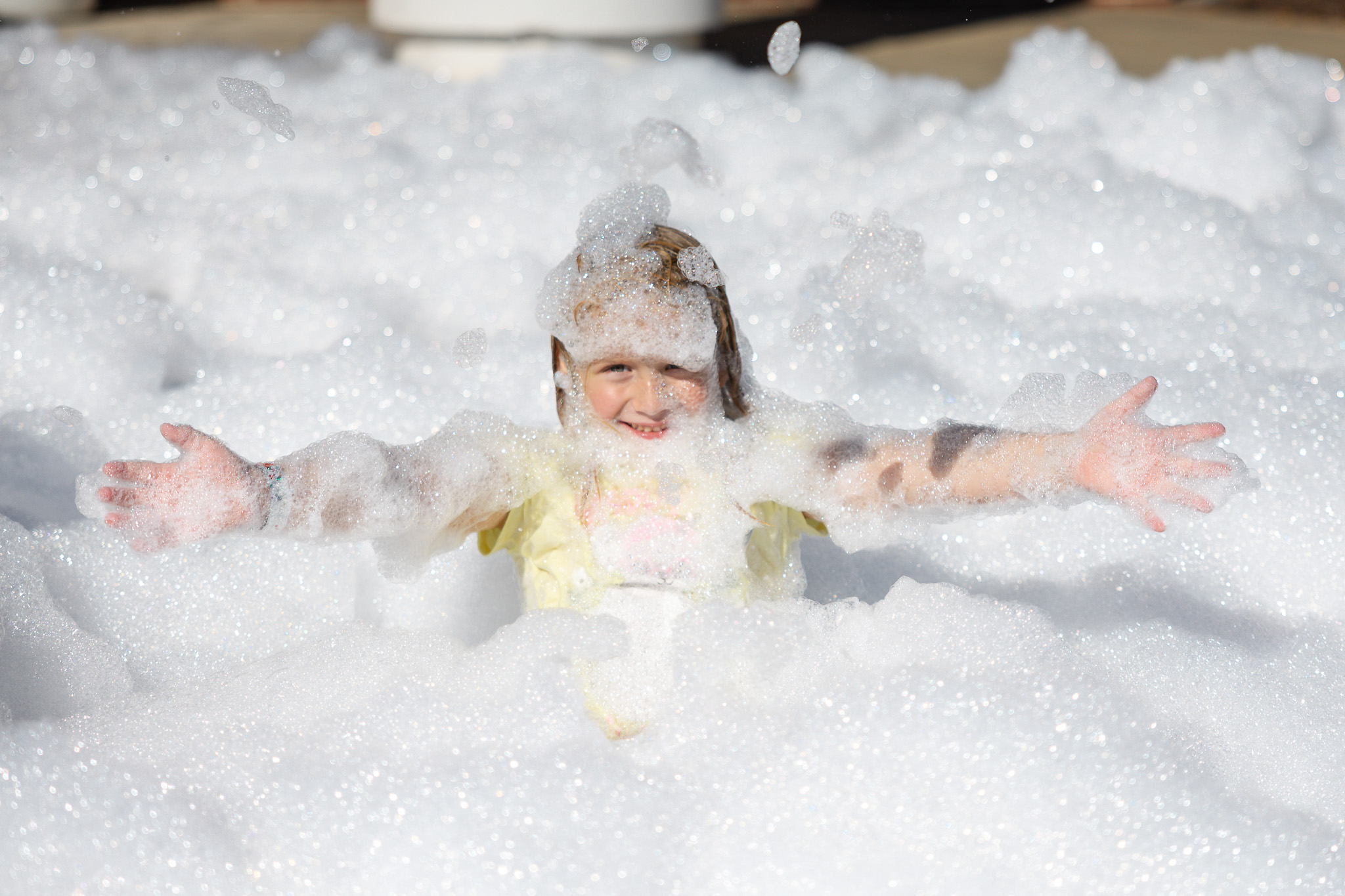 A Lower School student plays in bubbles at the 2025 HRA Fall Festival