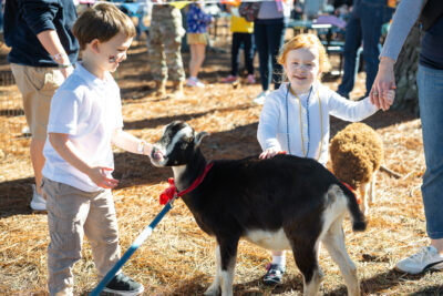 Lower School students with a goat at HRA's 2025 Fall Festival