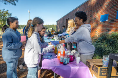 HRA Upper School students serve snow cones at the 2025 Fall Festival