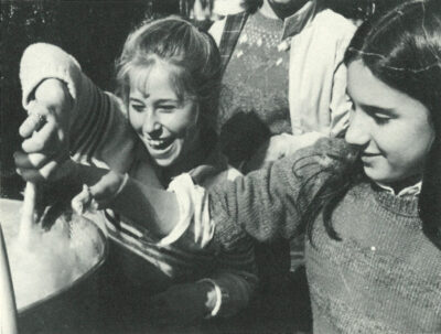 Smiling student volunteers making cotton candy at the first HRA Fall Festival in 1983