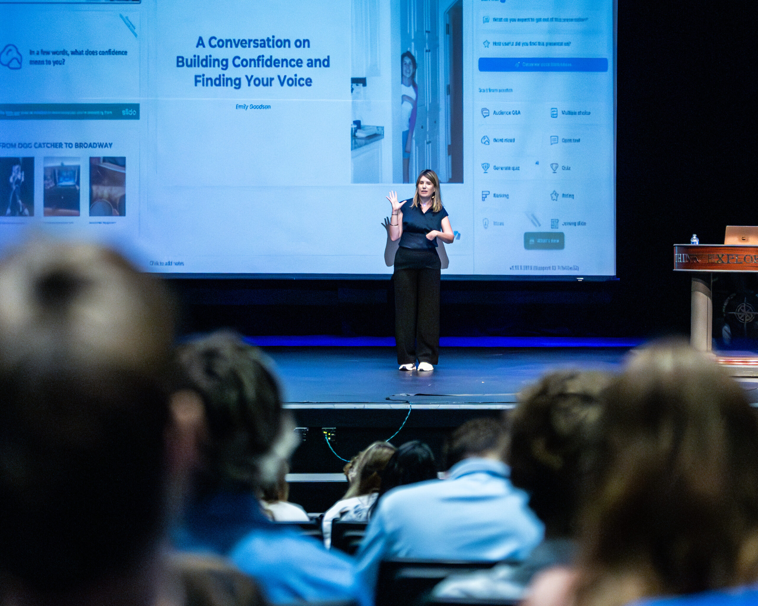 HRA alumna Emily Goodson '03 addressing students in front of a PowerPoint presentation at an assembly in September 2026