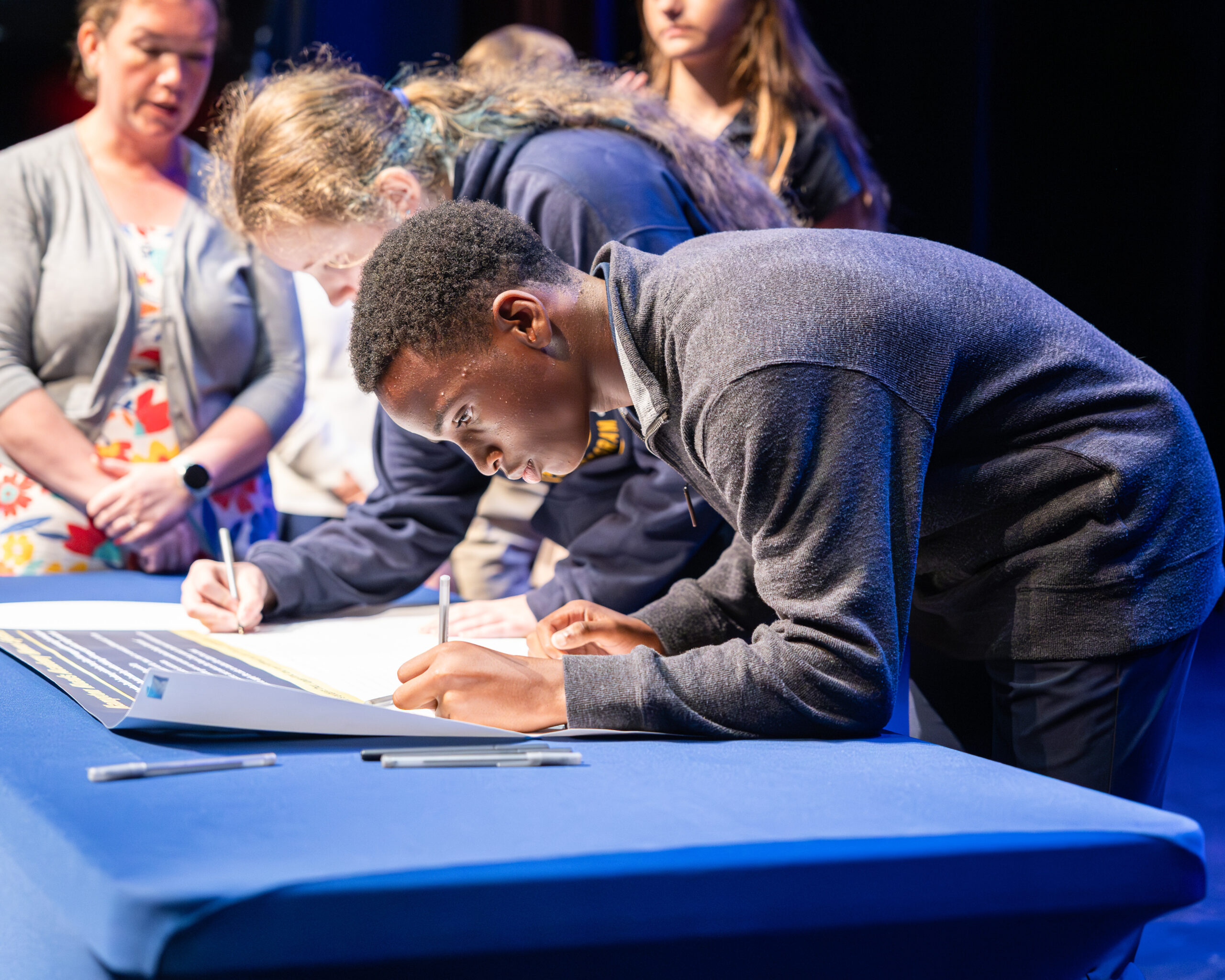HRA eighth grader signing the Honor Banner