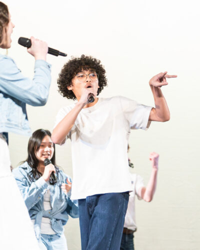 HRA senior Aaron Carlson '27 singing with the a cappella group Nowhere to Hide