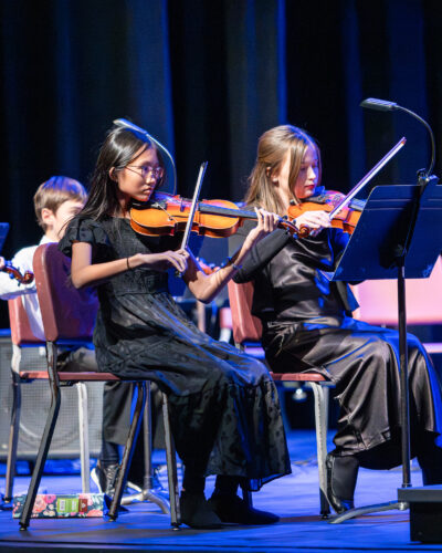 HRA students playing the violin during a concert