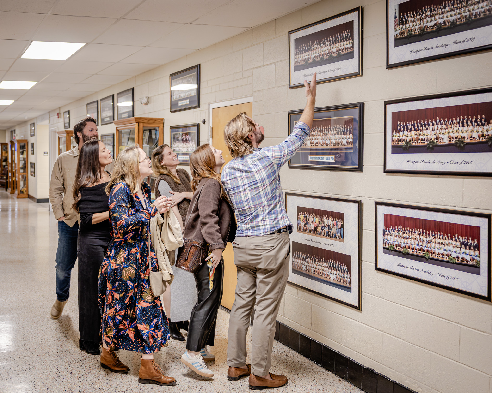 HRA alumni looking at class photos during a Homecoming weekend campus tour
