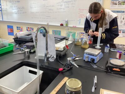 An HRA student working with biology lab equipment