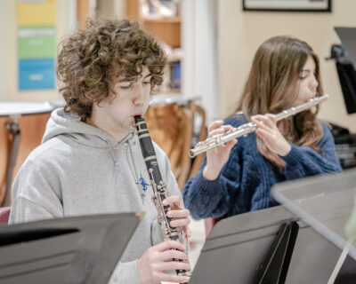 HRA clarinettist Wyatt Evelyn ’29 and flutist Ady Heder ’30 playing their instruments during a rehearsal for HRA's Veterans Day concert on November 11, 2026